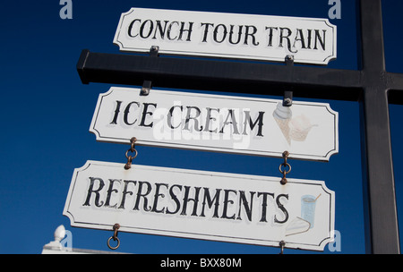 Signs for refreshments and attractions against a blue sky at Mallory Square, Key West, Florida, USA Stock Photo