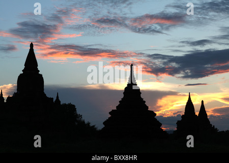 Silhouettes of Buddhist temples or pagodas at sunset in Bagan, Myanmar or Burma.