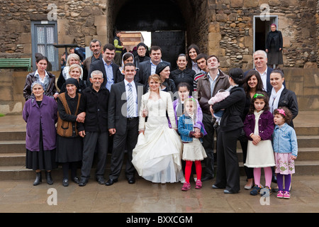 Georgian wedding group posing for photographs outside Sveti Tskhoveli Cathedral Mtskheta, Georgia. JMH4136 Stock Photo