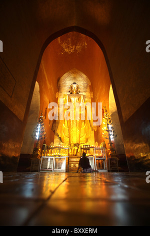 A giant golden Buddha Statue at an interior shrine in Ananda or Anandar Buddhist Temple in Bagan, Myanmar. (Burma)