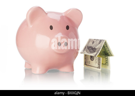 Piggy bank and money house on white backgound Stock Photo