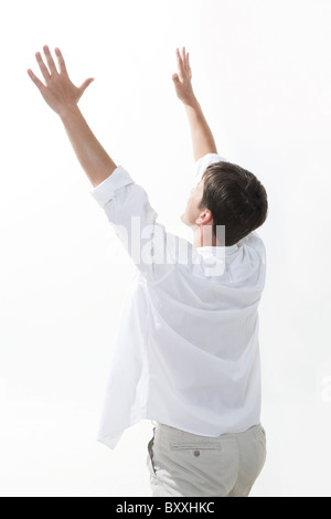 Image of excited man keeping his arms raised expressing enjoyment Stock Photo