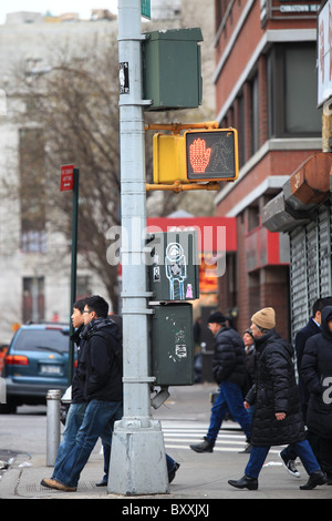 People walking through an intersection in Chinatown, New York city, 2010 Stock Photo