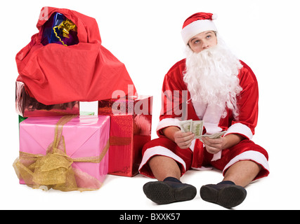 Photo of pensive Santa with dollars in hands thinking about something Stock Photo