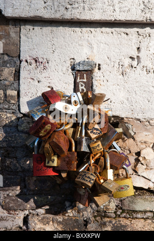 First love lock locks on the Milvio bridge chained to wall Rome Italy young teen lovers romantic movie italian style street Stock Photo