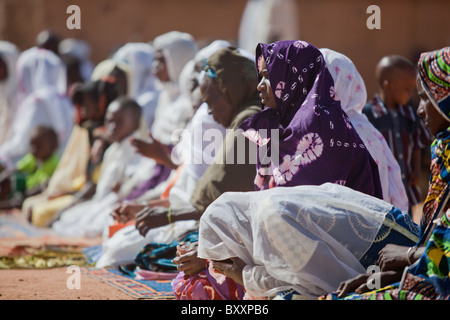 On the morning of Tabaski, men, women, and children alike converge on the great mosque of Djibo in northern Burkina Faso. Stock Photo