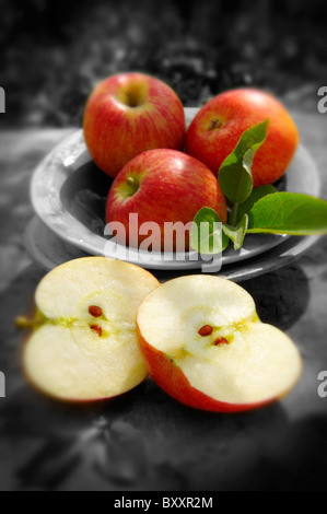 Fresh picked red apples, whole and cut Stock Photo