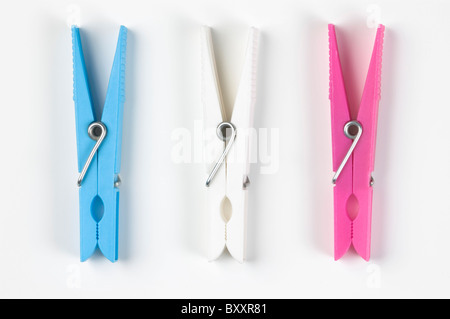 Three colorful plastic clothespins; on white. Stock Photo
