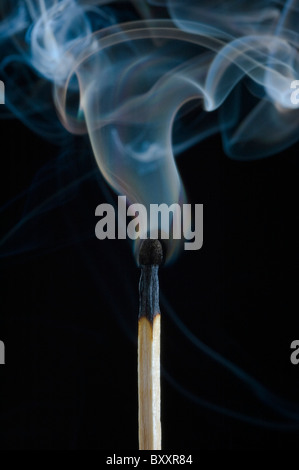 Smoke rising from a put-out safety match. Stock Photo