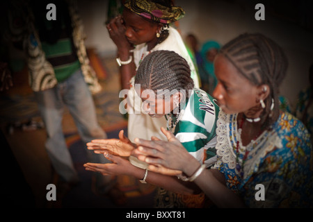 In the town of Djibo in northern Burkina Faso, a group of young women dance in traditional fashion. Stock Photo