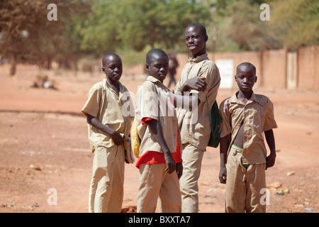 Junior high / high school students in uniform head home through the market in Djibo, northern Burkina Faso. Stock Photo