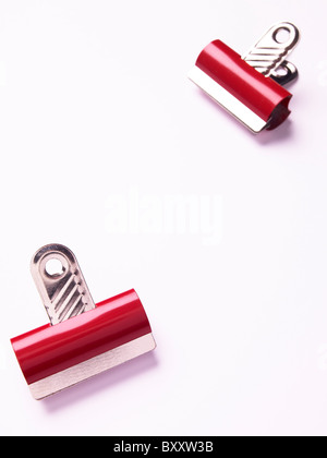 2 two red bulldog clips on a white background Stock Photo