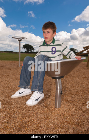 A MODEL RELEASED picture of an eleven year old boy in a play park in the Uk Stock Photo