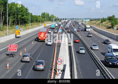 M25 motorway cross over lanes contra flow in road works widening to four lanes Civil Engineering project nears completion Essex countryside England UK Stock Photo