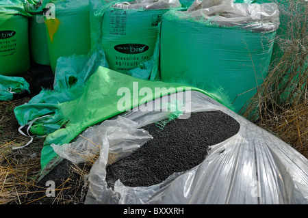 Bags of Biosolids fertiliser derived from sewage by Nutri Bio part of Anglian Water delivered to farm field in green FIBC jumbo bulk bag super sack UK Stock Photo