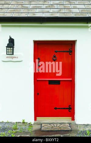 Front door in stable-door style on traditional whitewashed cottage near Quilty, County Clare, West of Ireland Stock Photo