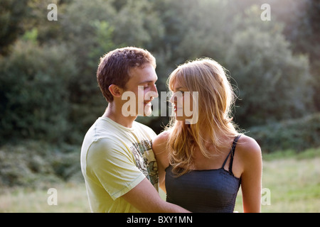 A romantic young couple standing outdoors Stock Photo