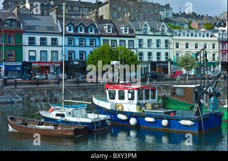 Popular as a tourist destination Cobh harbour with brightly coloured fishing boats in County Cork, Ireland Stock Photo