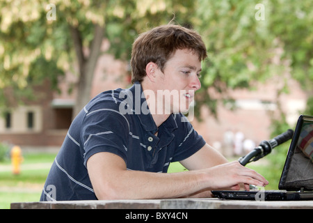 Young man typing on laptop computer Stock Photo