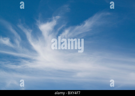 Wispy cirrus clouds against a blue sky Stock Photo