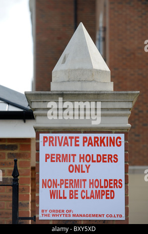 A car clamping company notice in a private car park for residential apartments UK Stock Photo