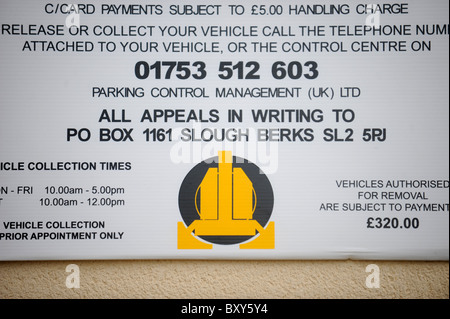 A car clamping company notice in a private car park for residential apartments UK Stock Photo