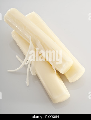 Three pieces of mozzarella string cheese isolated on white background Stock Photo