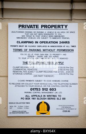 A car clamping company notice in a private car park for residential apartments UK Stock Photo