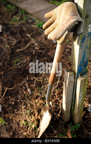 Gardening Gloves Resting on Spade at Allotment. Stock Photo