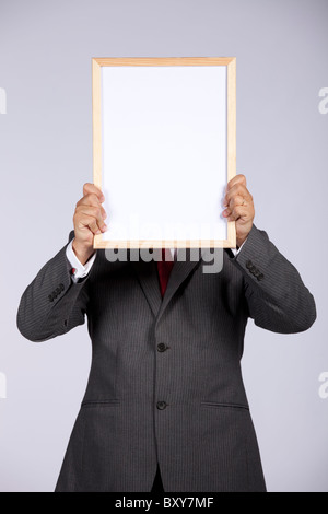 businessman holding a blank whiteboard Stock Photo
