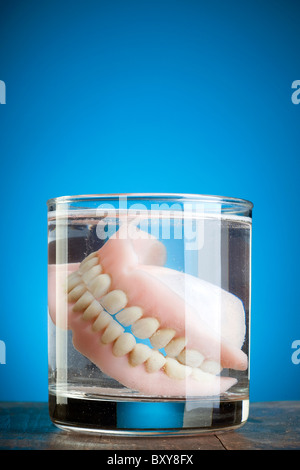 a pair of dentures in a glass of water Stock Photo