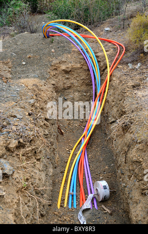 Colorful fiber optical cables are buried in a ditch. South Africa. Stock Photo