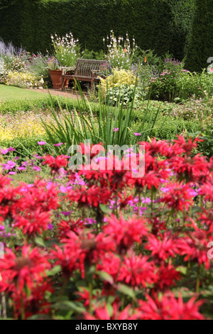 Abbeywood Garden, Cheshire. Summer view of Abbeywood’s Pool Garden with Monarda Gardenview Scarlet in the foreground. Stock Photo