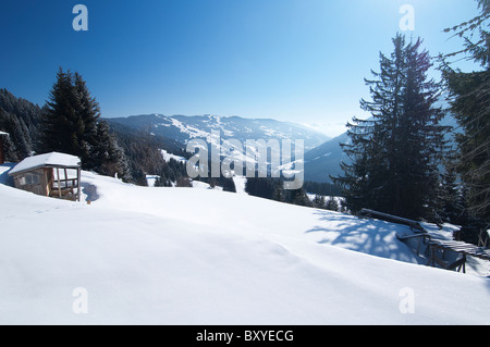 small cabin in virgin snow over looking the Hinterglemm Valley. skiing resort Austria Stock Photo