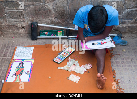 handicapped man drawing pictures to earn a living in Kathmandu, Nepal Stock Photo