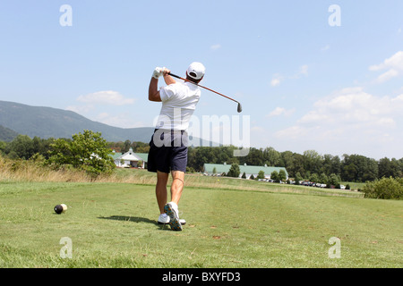 Golfer tees off at a local golf course in Charlottesville, VA. Stock Photo