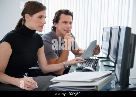 Man and woman working with computers Stock Photo