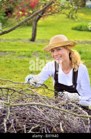 Young woman cleaning tree limbs Stock Photo