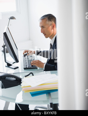 Businessman working on computer in office Stock Photo