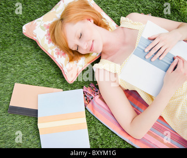 Young woman relaxing on lawn Stock Photo