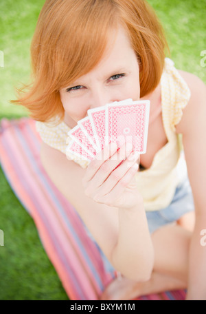 Young woman holding cards Stock Photo