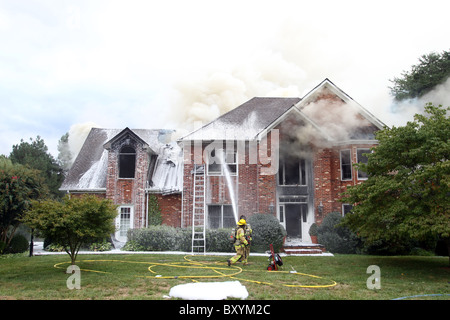 Firefighters take turns putting out a house fire in Charlottesville, Virginia. Stock Photo