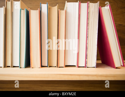 Row of books on shelf Stock Photo