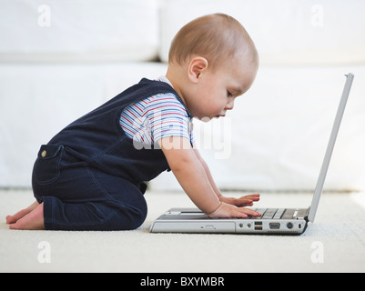 Baby boy using laptop Stock Photo