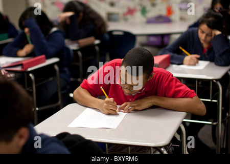 Hispanic and African American students take a test in their classroom at Peak Preparatory Academy, a public charter high school Stock Photo