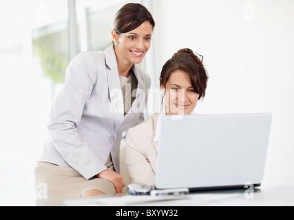 Female office workers using laptop Stock Photo