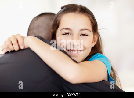 Father coming back from work embracing daughter Stock Photo