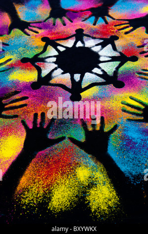 One world unity symbol surrounded by childrens hand prints made with multicoloured powder Stock Photo