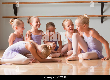 Female ballet dancers talking in dance studio Stock Photo