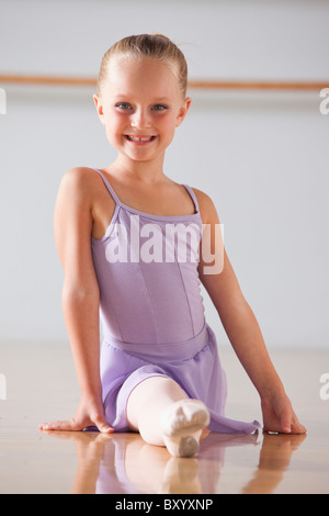 Portrait of ballet dancer performing splits in dance studio Stock Photo